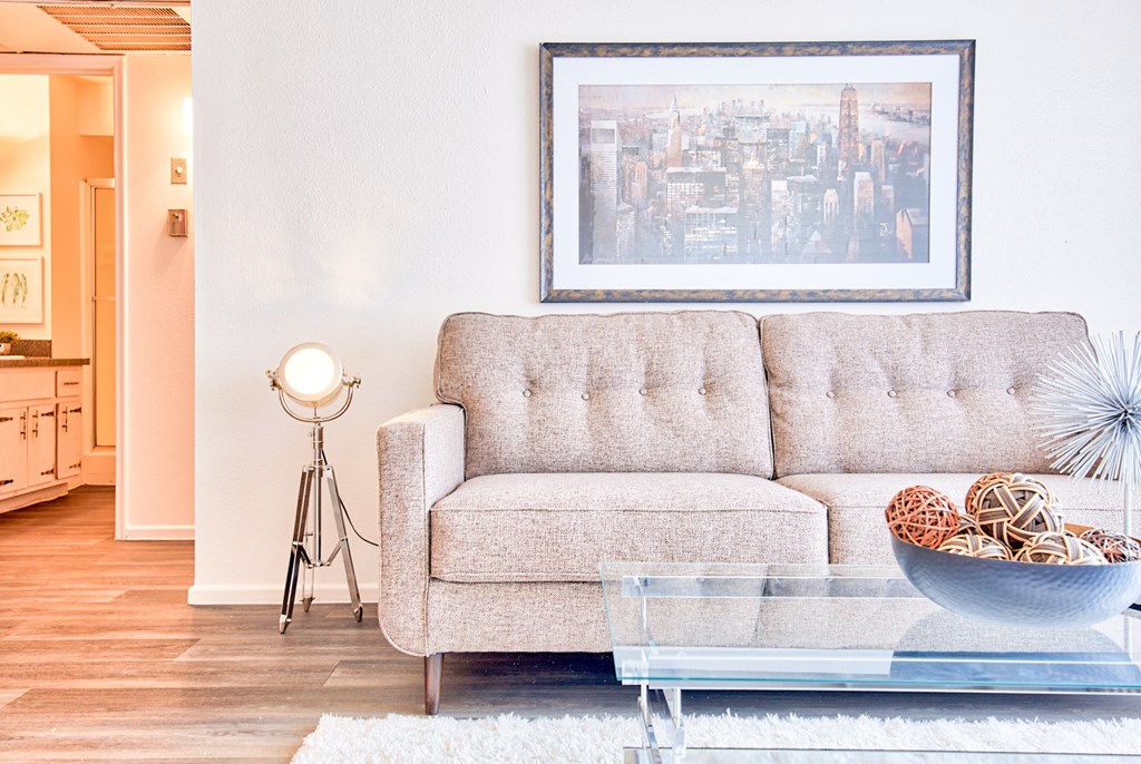 a living room with a couch and a glass coffee table
