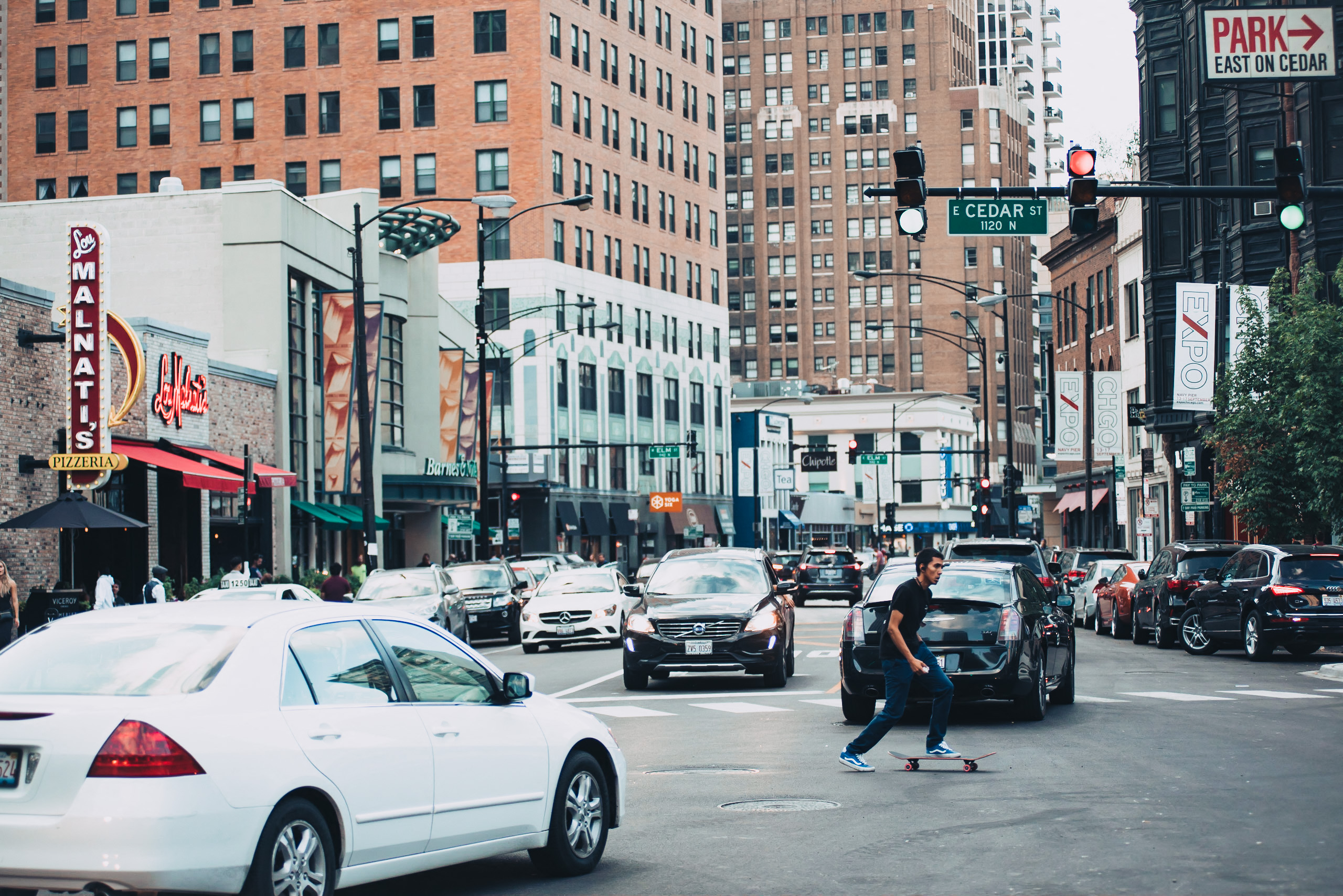 a man riding a skateboard down a busy city street
