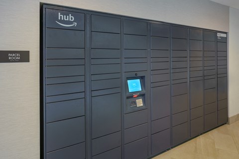 a set of lockers in a hallway with a hud screen on the door