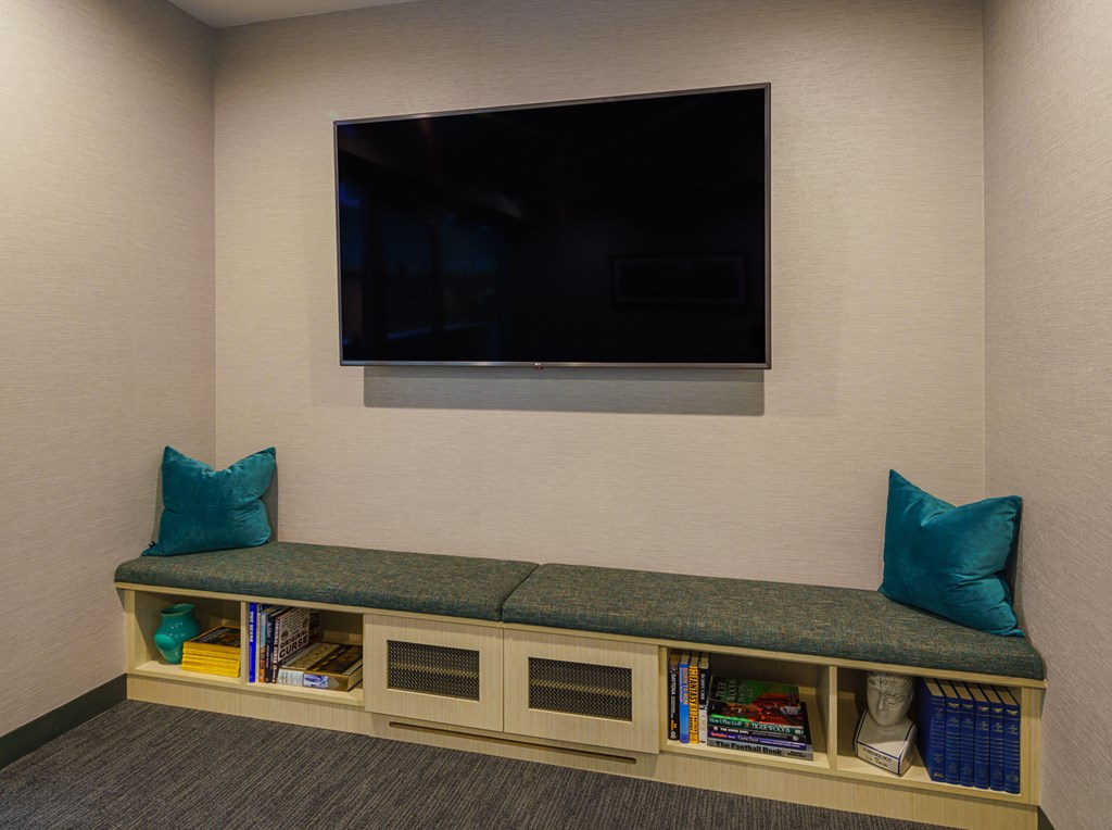 a small room with a couch and a television