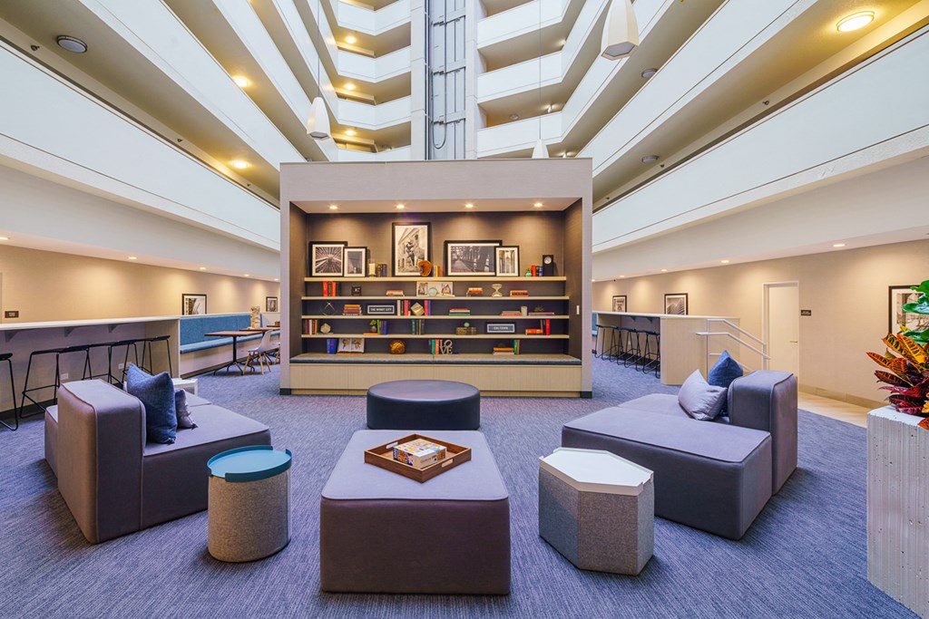 the lobby of a library with couches and tables