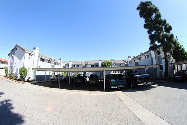 a parking lot with cars in front of a building