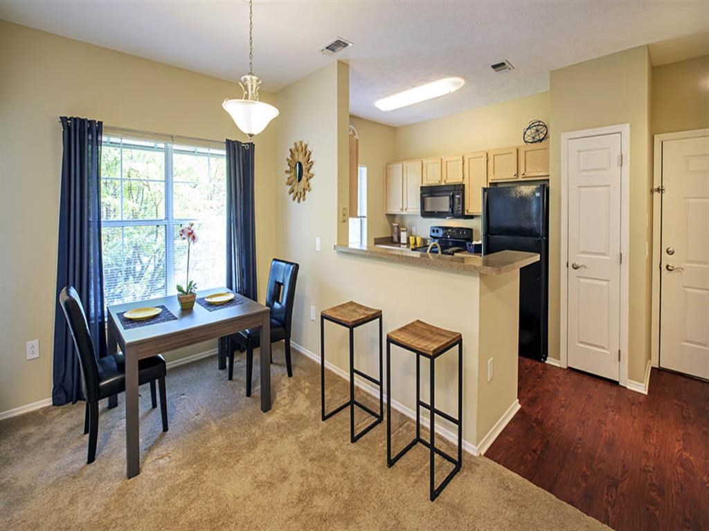 a kitchen and dining room with a table and chairs