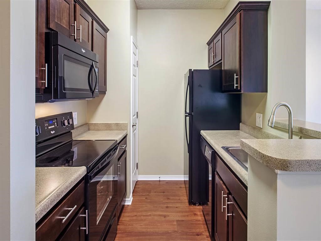 a kitchen with a stove and a refrigerator