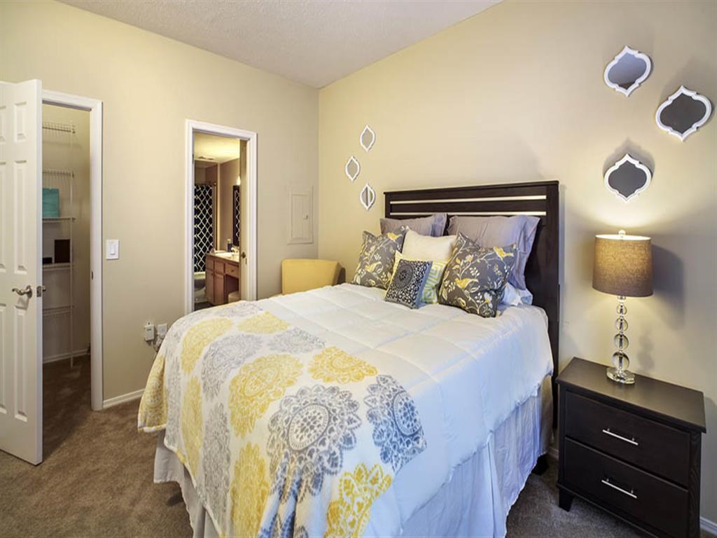 a bedroom with a bed and a door to a bathroom