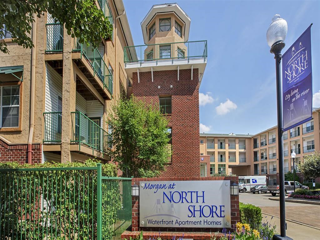 an apartment building with a sign for the north shore neighborhood apartment homes