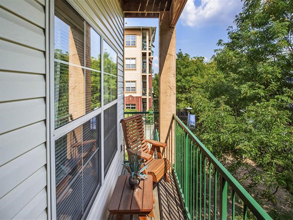 a balcony with two chairs and a table on it