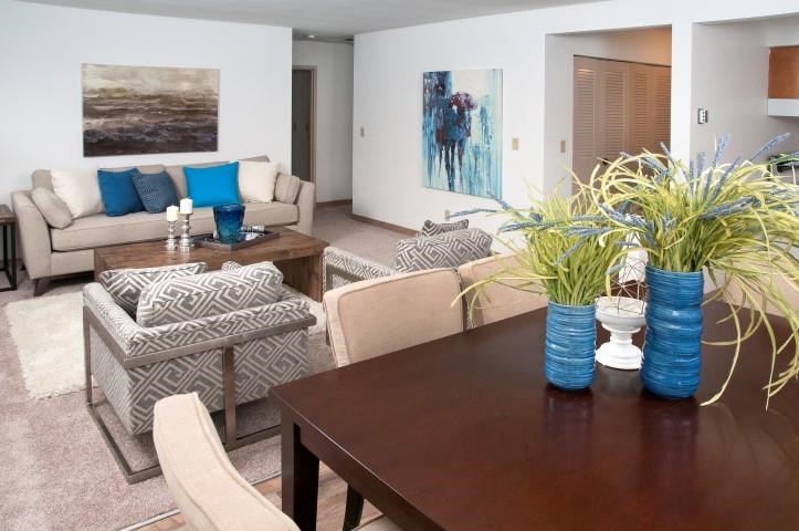 a living room with a wooden table and chairs