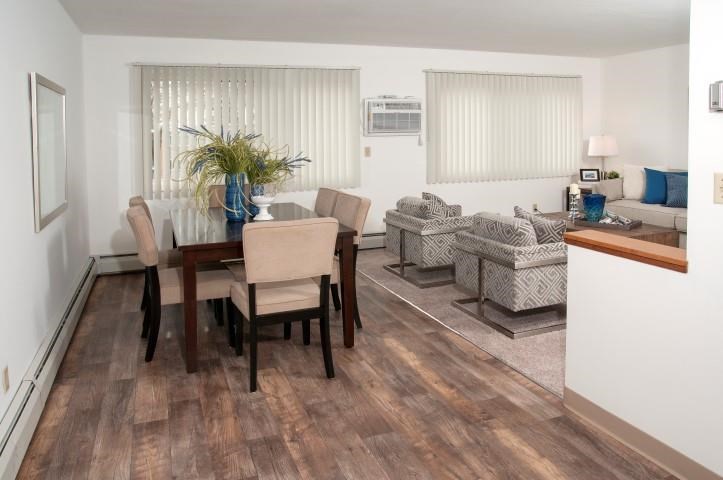 a living room and dining room with a table and chairs