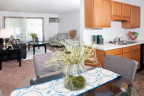 a dining room table with a vase of flowers on top of it