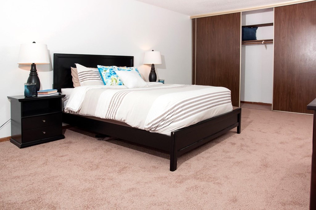 a bedroom with a bed and a closet