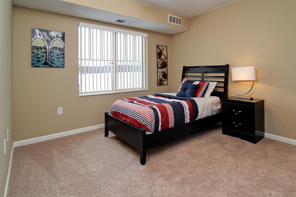 a bedroom with a bed and a window