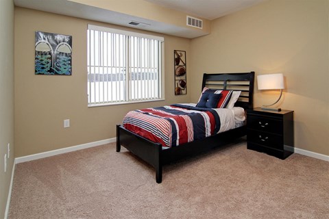 a bedroom with a bed and a window