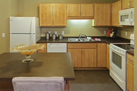 a kitchen with white appliances and wooden cabinets