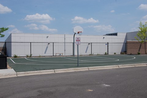 a basketball court in front of a building on a city street