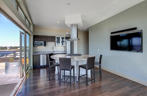 A modern kitchen with a dining table and chairs.