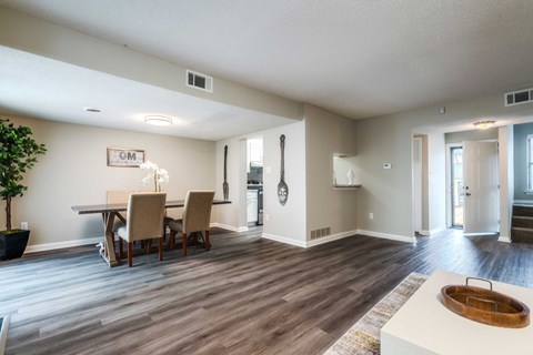 a dining room and living room with a table and chairs