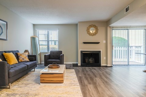 a living room with a couch and a coffee table and a fireplace