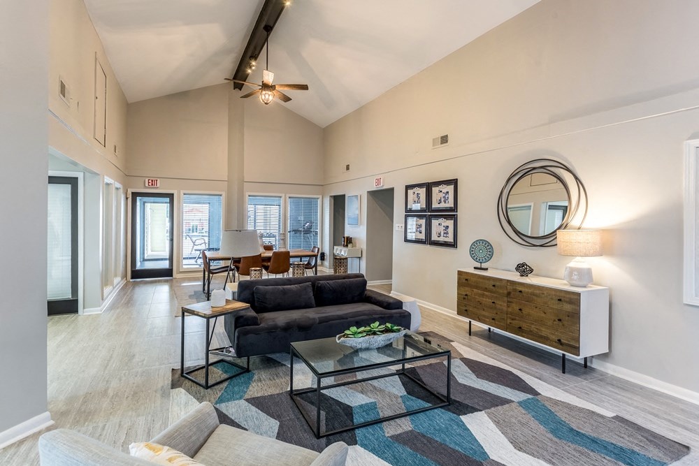 a living room with a couch and a glass coffee table
