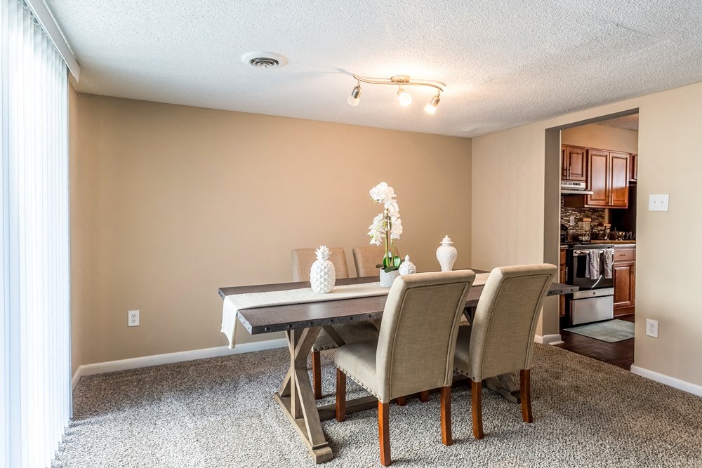an empty dining room with a table and chairs