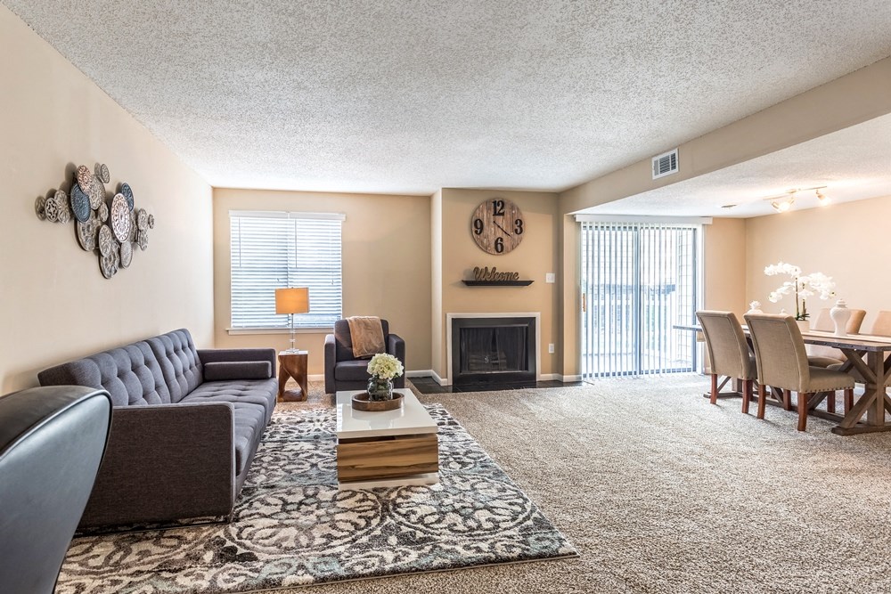 a living room with a couch and a table and a fireplace