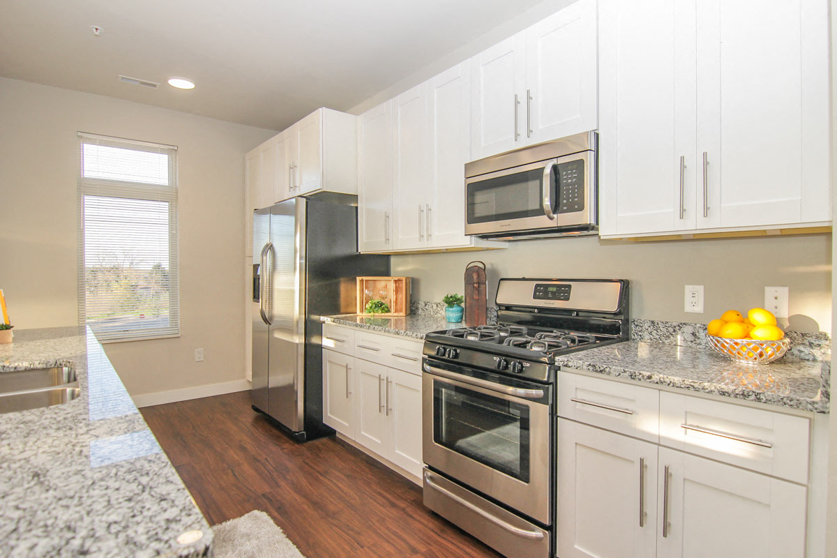 a kitchen with stainless steel appliances and white cabinets