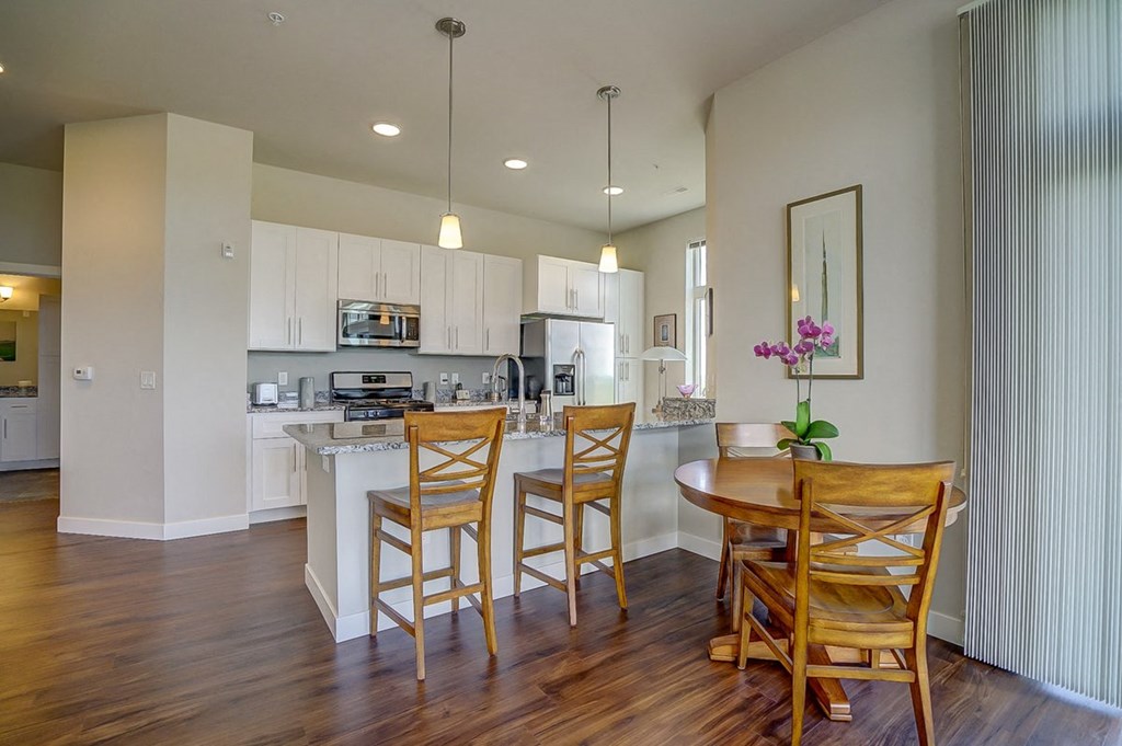 a kitchen and dining area with a table and chairs