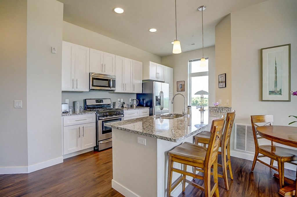 a kitchen with an island and a table with chairs