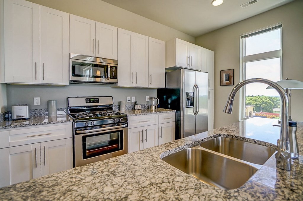 a kitchen with granite counter tops and stainless steel appliances