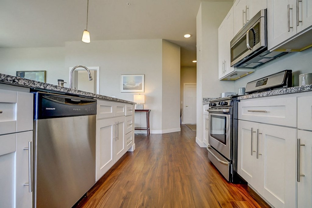 a kitchen with stainless steel appliances and white cabinets