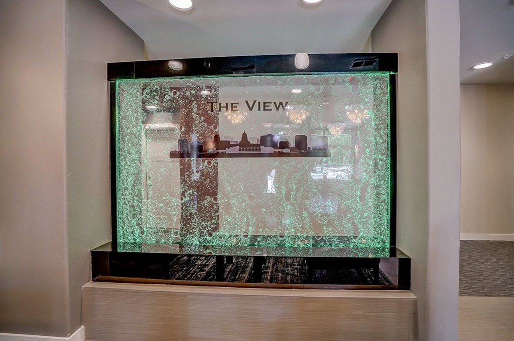 a large glass display case with a view of a building