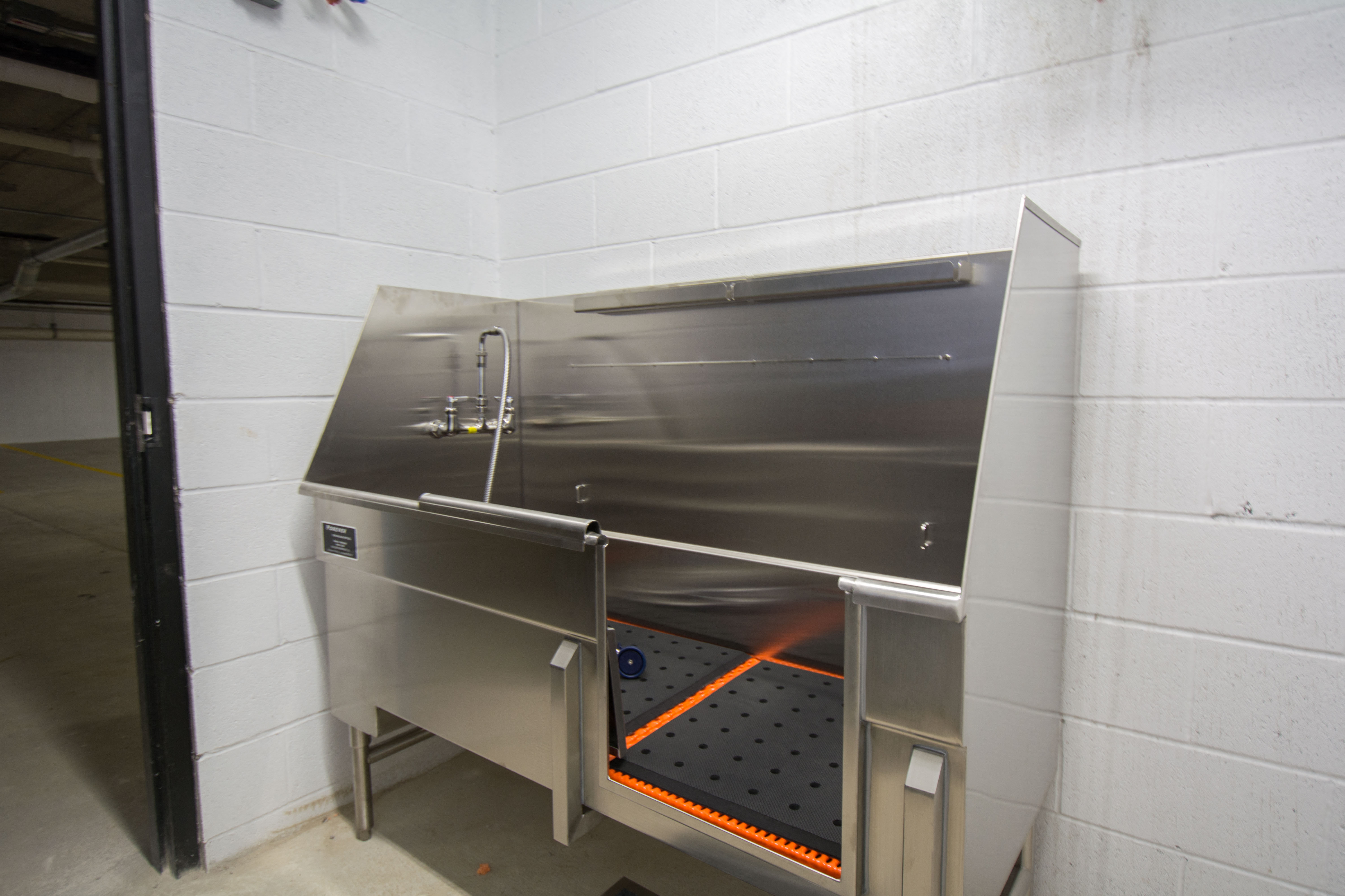 a large stainless steel sink in a white room