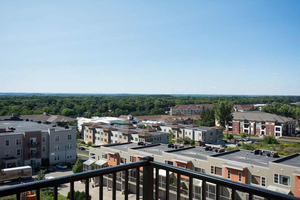 a view of the city from the balcony of a apartment building