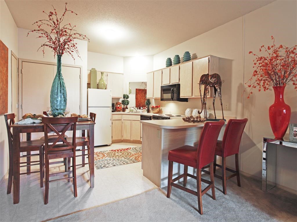 a kitchen and dining room with a table and chairs