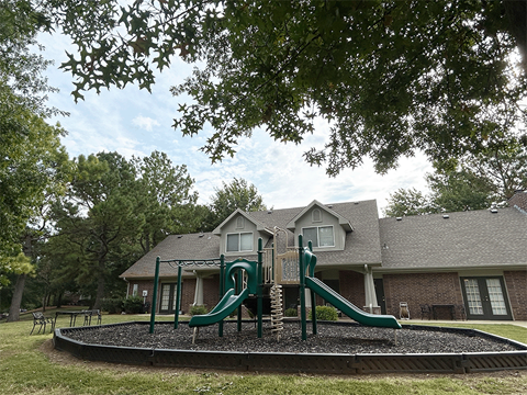 a childrens playground in front of a house