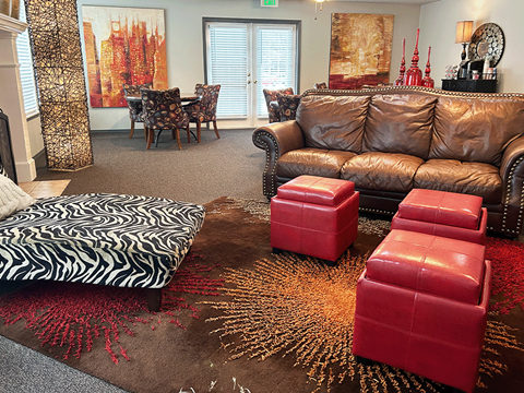 a living room with leather furniture and a zebra rug