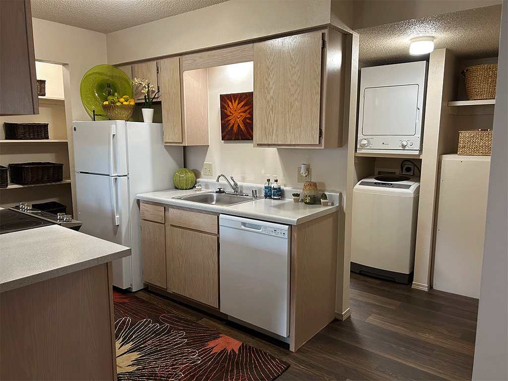 a kitchen with white appliances and a sink and a refrigerator
