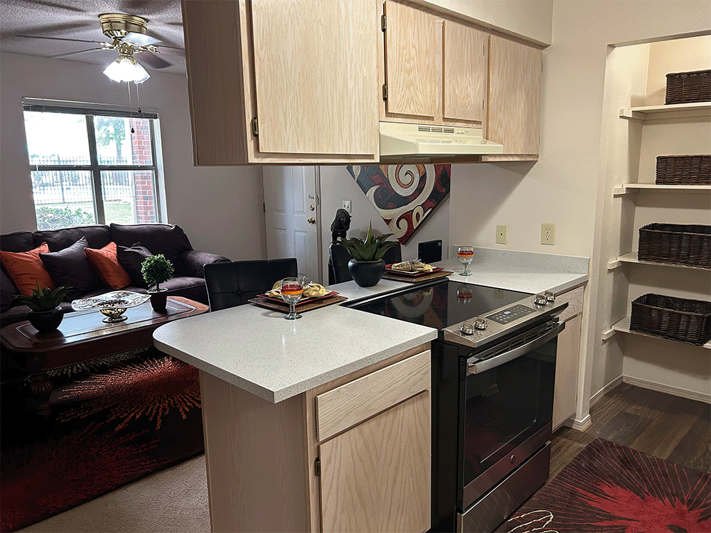 a kitchen with an island and a living room with a couch