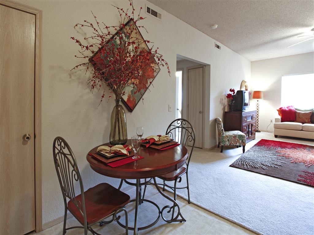 a dining room with a table and chairs and a living room