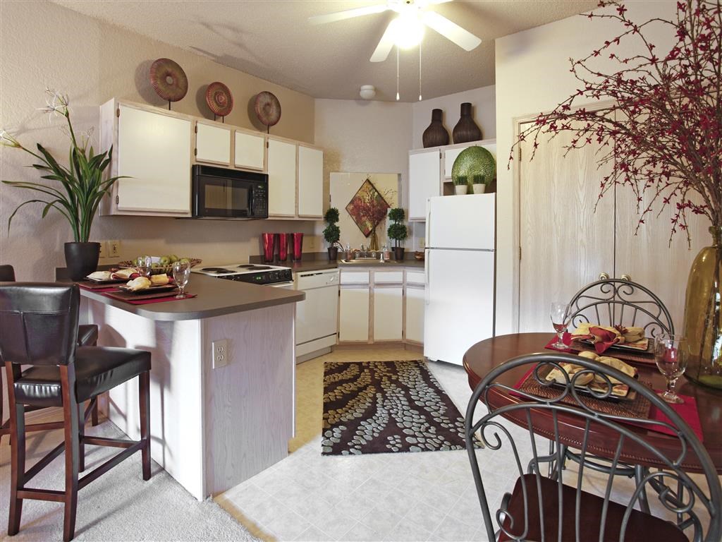 a kitchen and dining room with a table and chairs