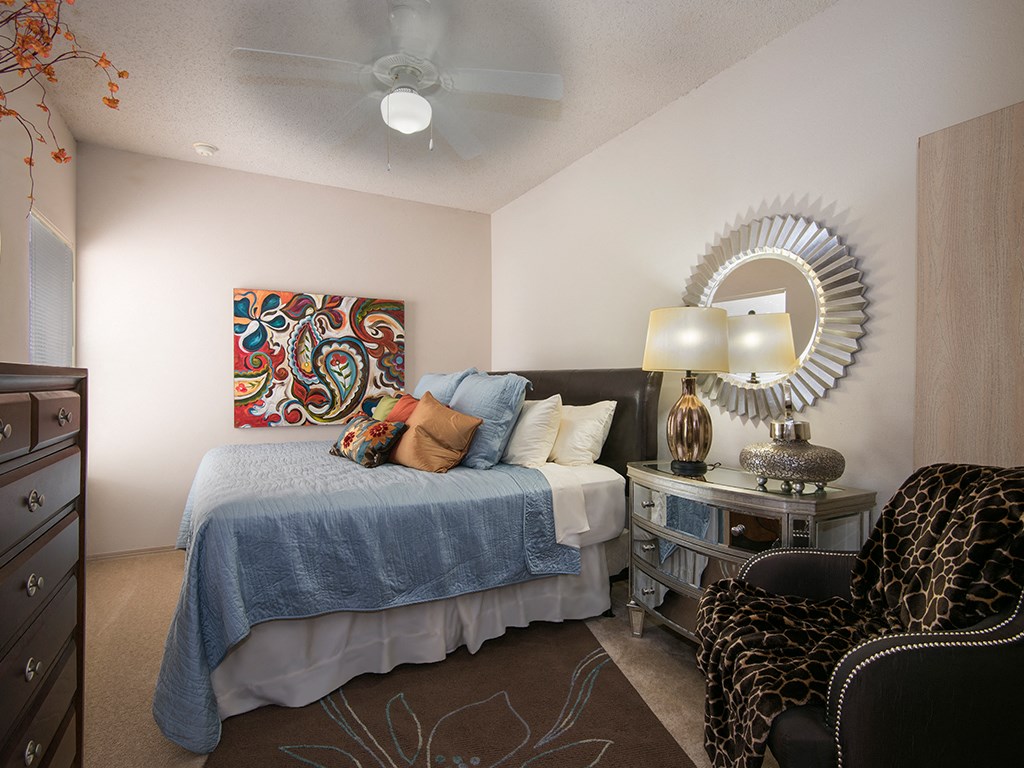 a bedroom with a bed and a ceiling fan