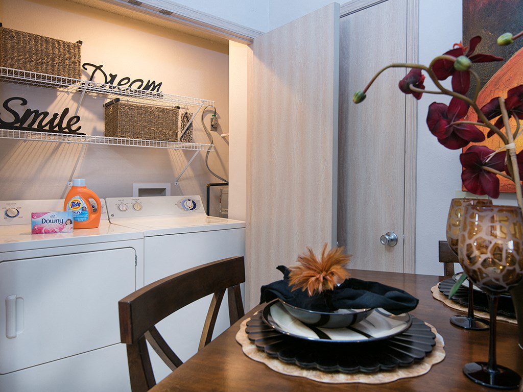 a kitchen and dining room with a table and a washing machine