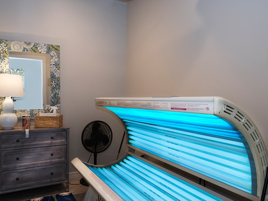 a spa tub in a room with a mirror and a dresser