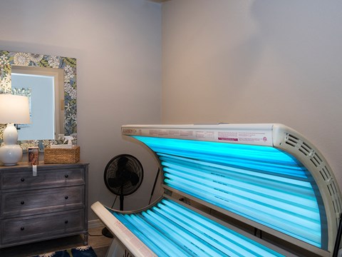 a spa tub in a room with a mirror and a dresser