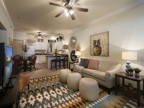 a living room with a couch and a ceiling fan