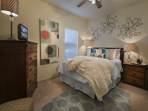 a bedroom with a bed and a ceiling fan