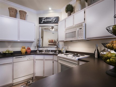 a kitchen with white cabinets and a counter top