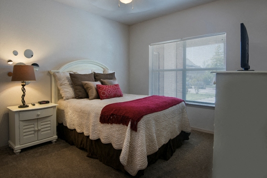 a bedroom with a bed and a window