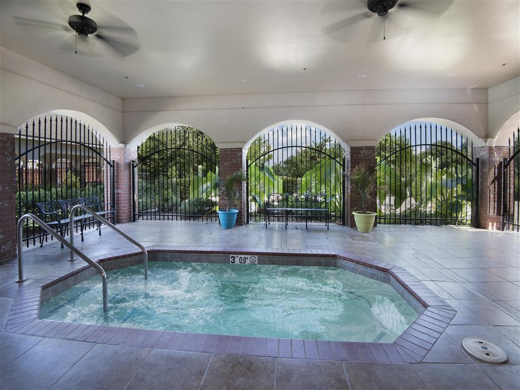 the indoor pool is heated and has two ceiling fans