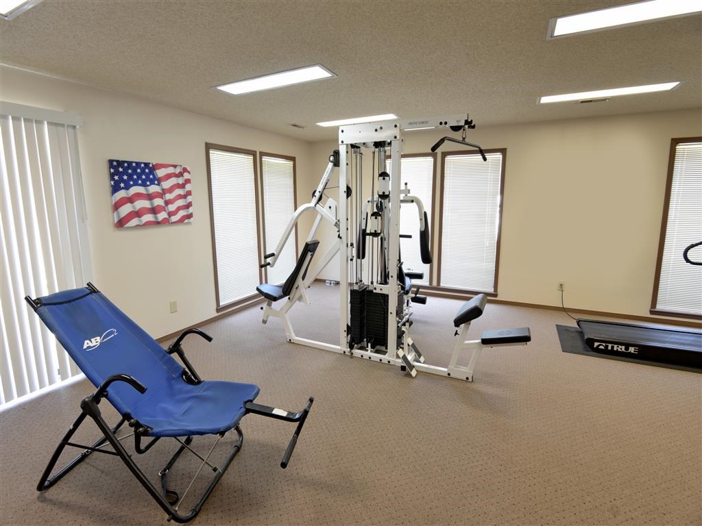 a gym with a chair and equipment in a room